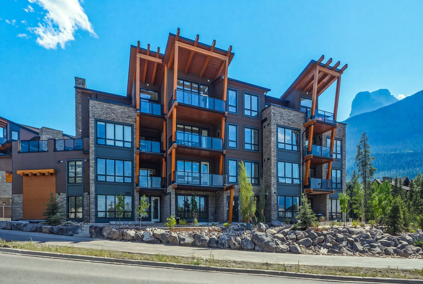 Exterior of The Summit Collection buildings against the Canadian Rockies